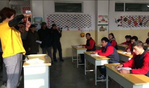 Chinese authorities lead a group of foreign journalists on a tour of a 'vocational center' in Xinjiang, Jan. 4, 2019.
